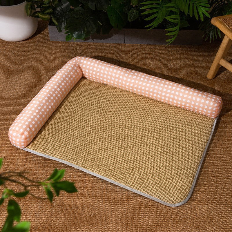 Pet bed with a checkered pink border on a brown mat