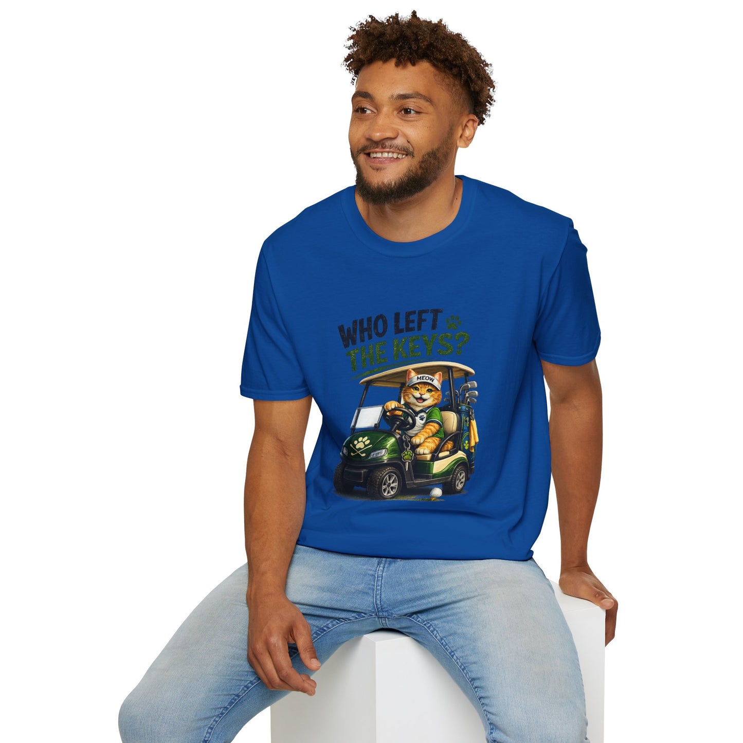 A royal blue short-sleeve crewneck t-shirt featuring a cartoon graphic of a cat driving a green golf cart with the text 'WHO LEFT THE KEYS?' printed on the chest.