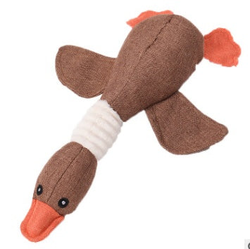Brown fabric duck toy with orange beak and feet on a white background