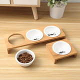 Pet feeding station with three bowls on a wooden surface