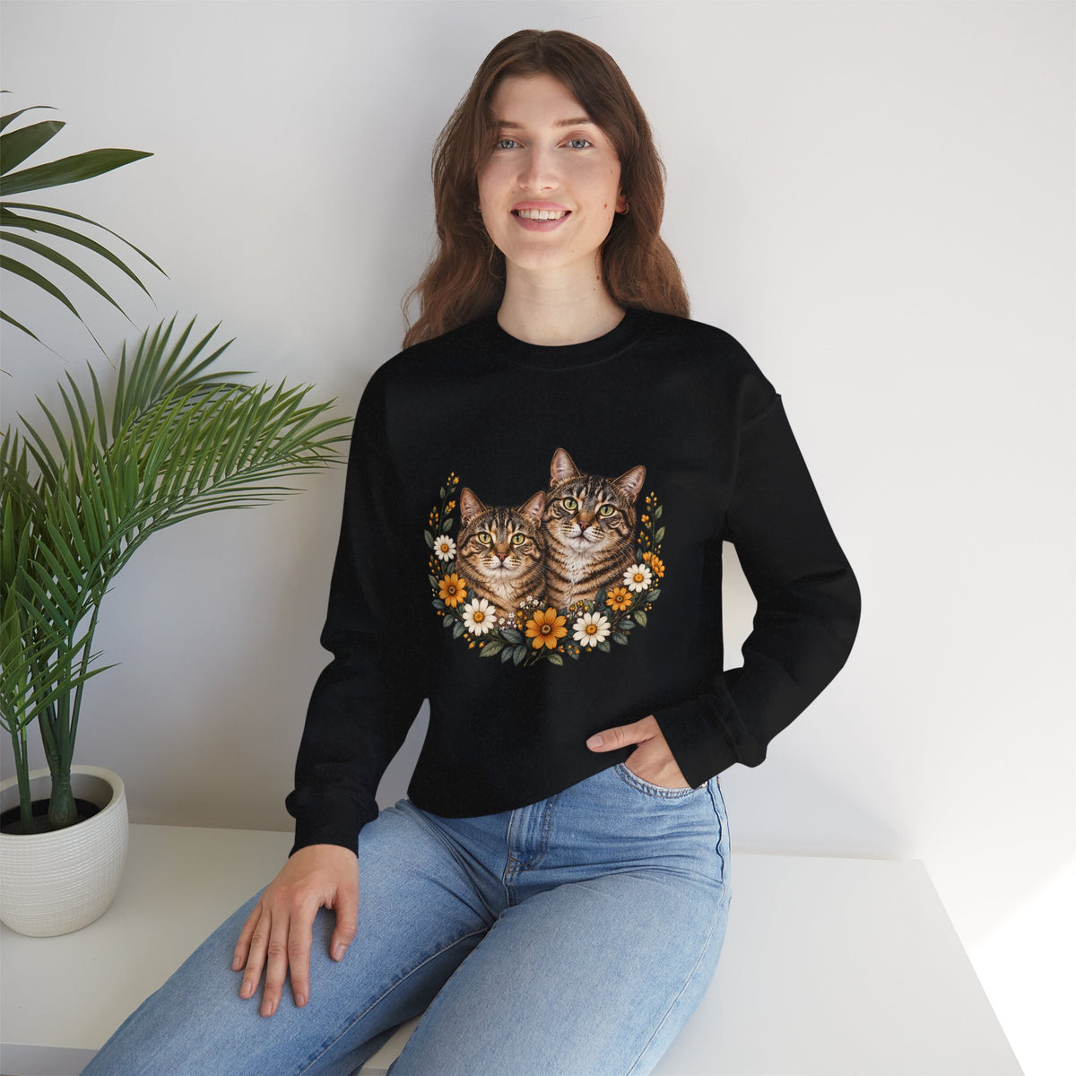 Two tabby cats and wildflowers printed on a black unisex crewneck sweatshirt