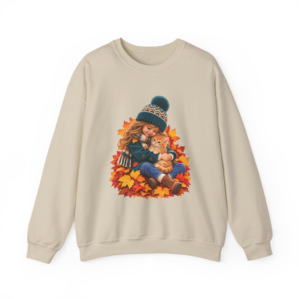 Sand crewneck sweatshirt featuring a little girl cuddling an orange tabby kitten among autumn leaves