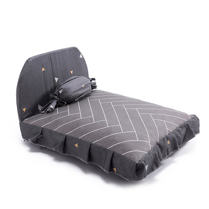 Gray patterned seat cover with a small bag on a white background