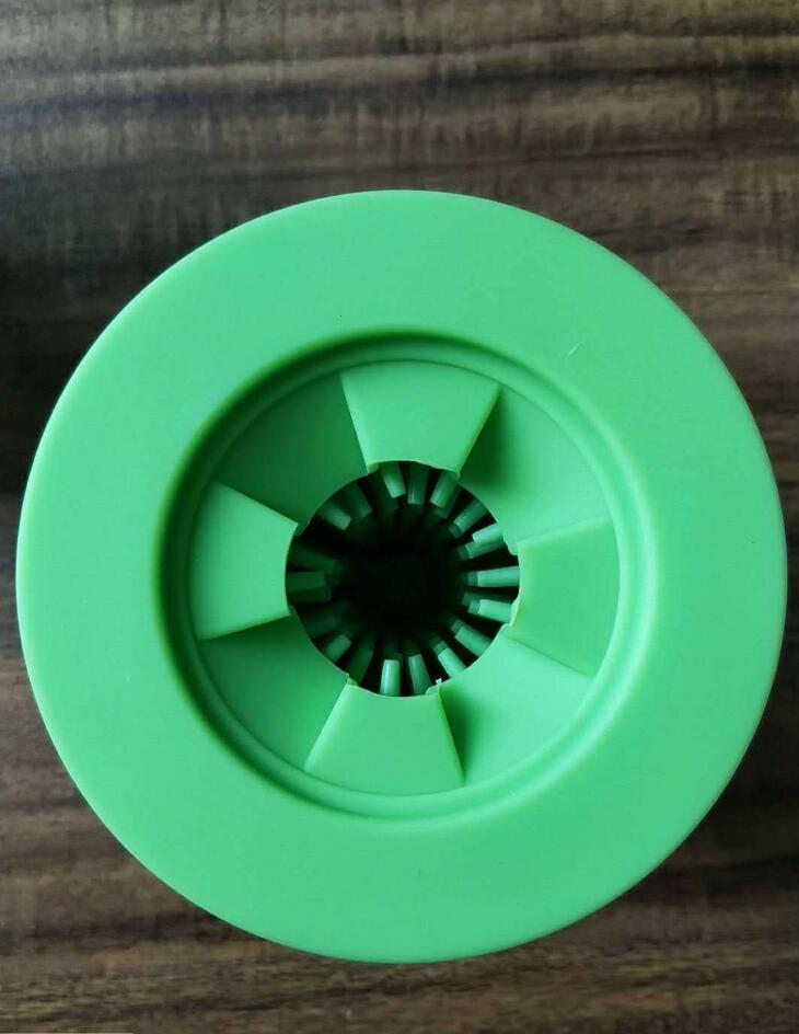 Green plastic wheel on a wooden surface