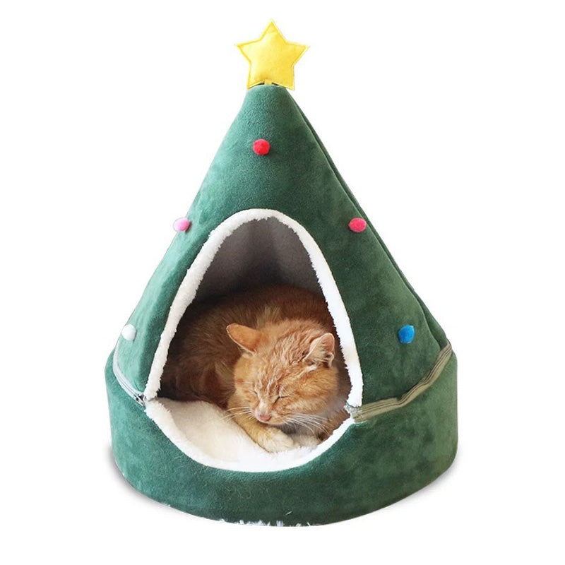 Green Christmas tree-shaped pet bed with a cat inside on a white background