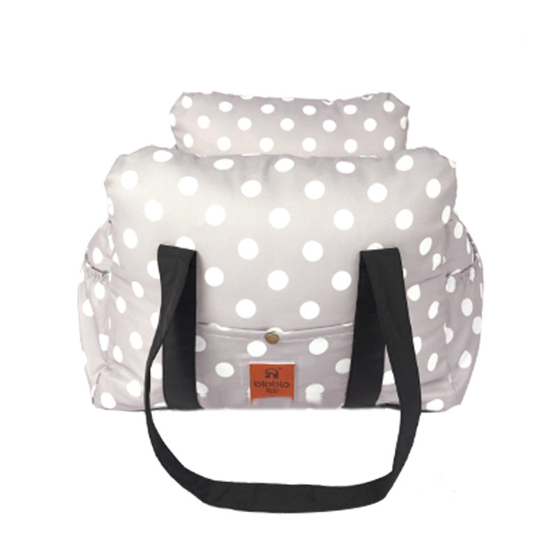 Polka dot bag with black straps on a white background