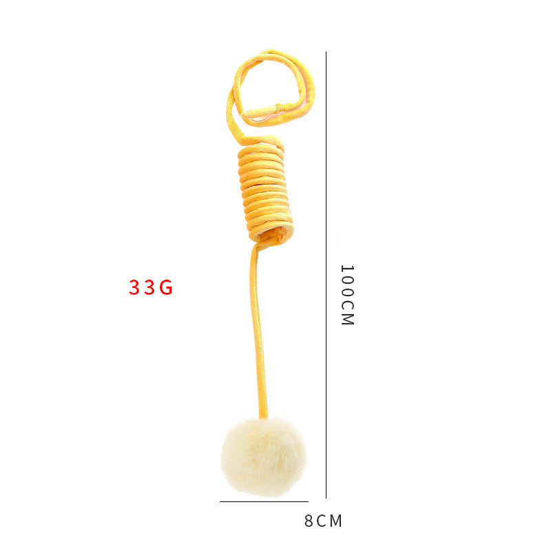 Yellow spring toy with a white pom-pom, showing weight and dimensions on a white background.