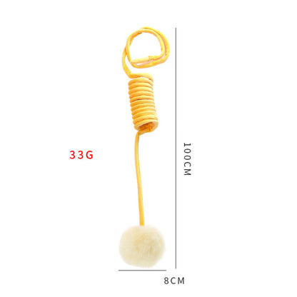 Yellow spring toy with a white pom-pom, showing weight and dimensions on a white background.