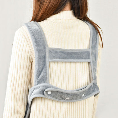 Person wearing a gray back brace against a plain background
