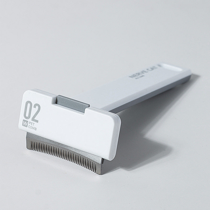 Pet grooming tool with comb on a light gray background