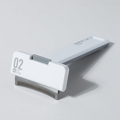 Pet grooming tool with comb on a light gray background
