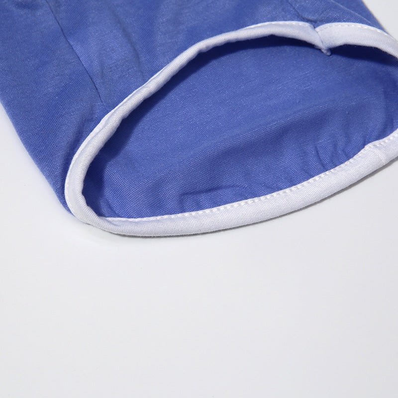 Close-up of a blue fabric with white trim on a light gray background