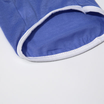 Close-up of a blue fabric with white trim on a light gray background