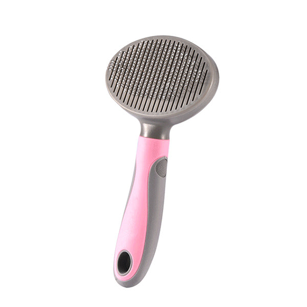 Pet grooming brush with pink handle and metal bristle head on a white background