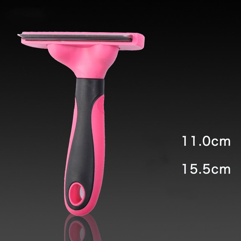 Pink and black pet grooming brush with measurements on a dark background