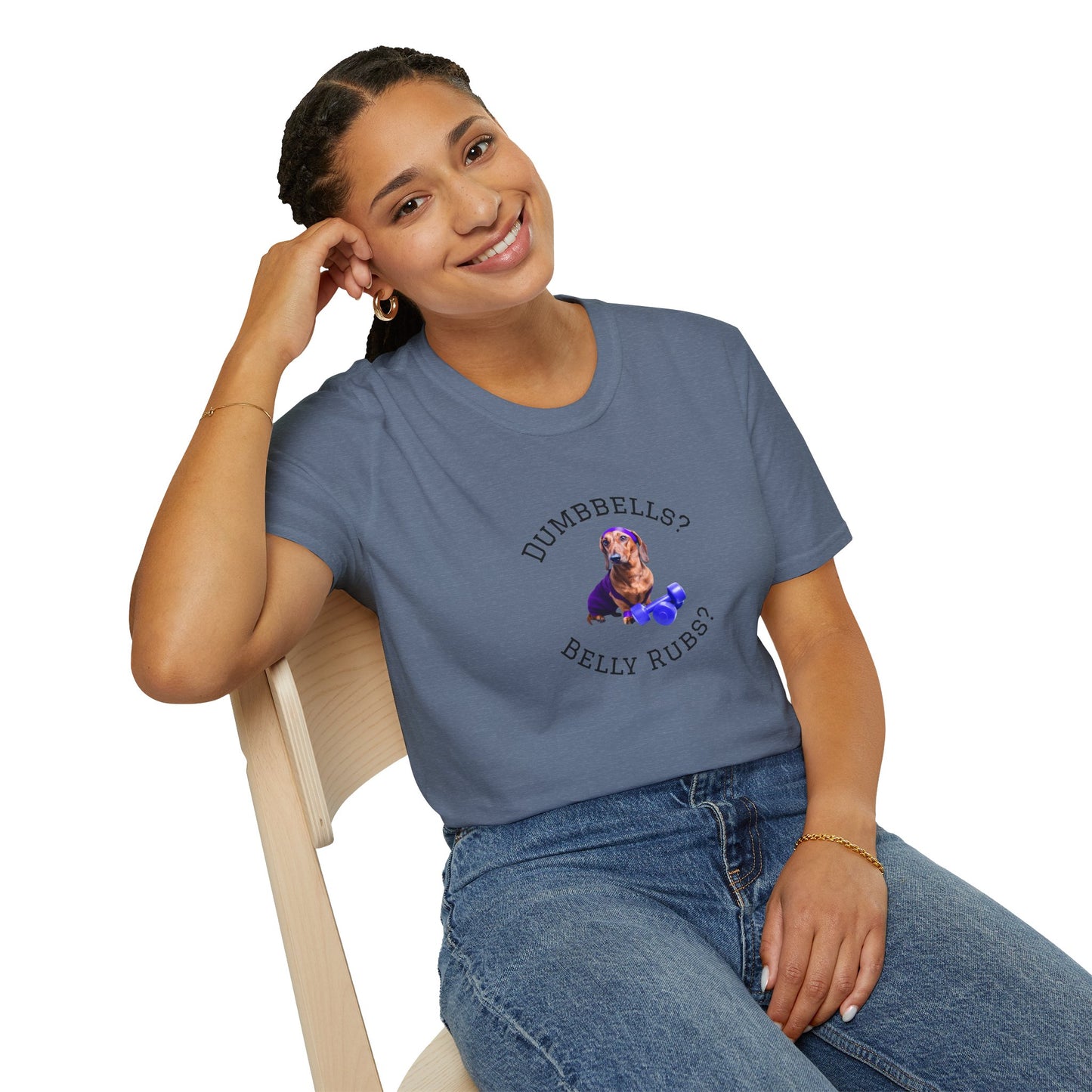 Woman wearing a gray t-shirt with text and graphics, sitting on a chair.