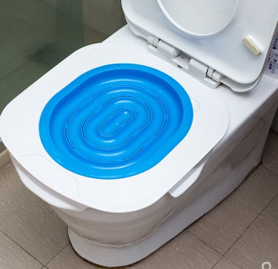 White toilet with a blue plastic seat cover on a tiled floor.