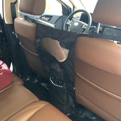 Brown car interior with a black plastic cover over the seats