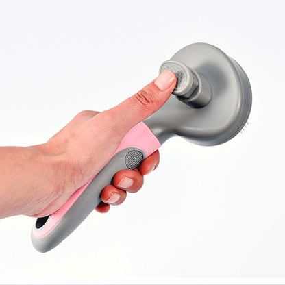 Hand holding a gray and pink shower head against a white background