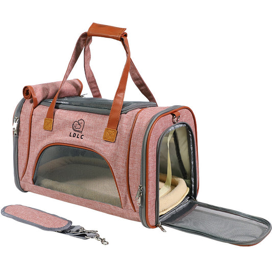 Pink pet carrier with brown straps on a white background