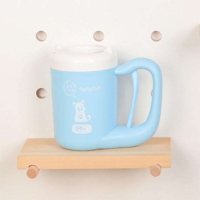 Light blue mug with a white lid on a wooden shelf against a light background
