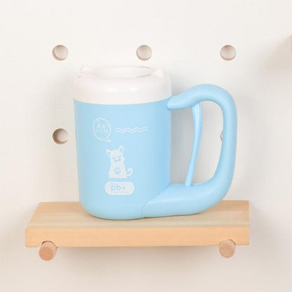 Light blue mug with a white lid on a wooden shelf against a light background