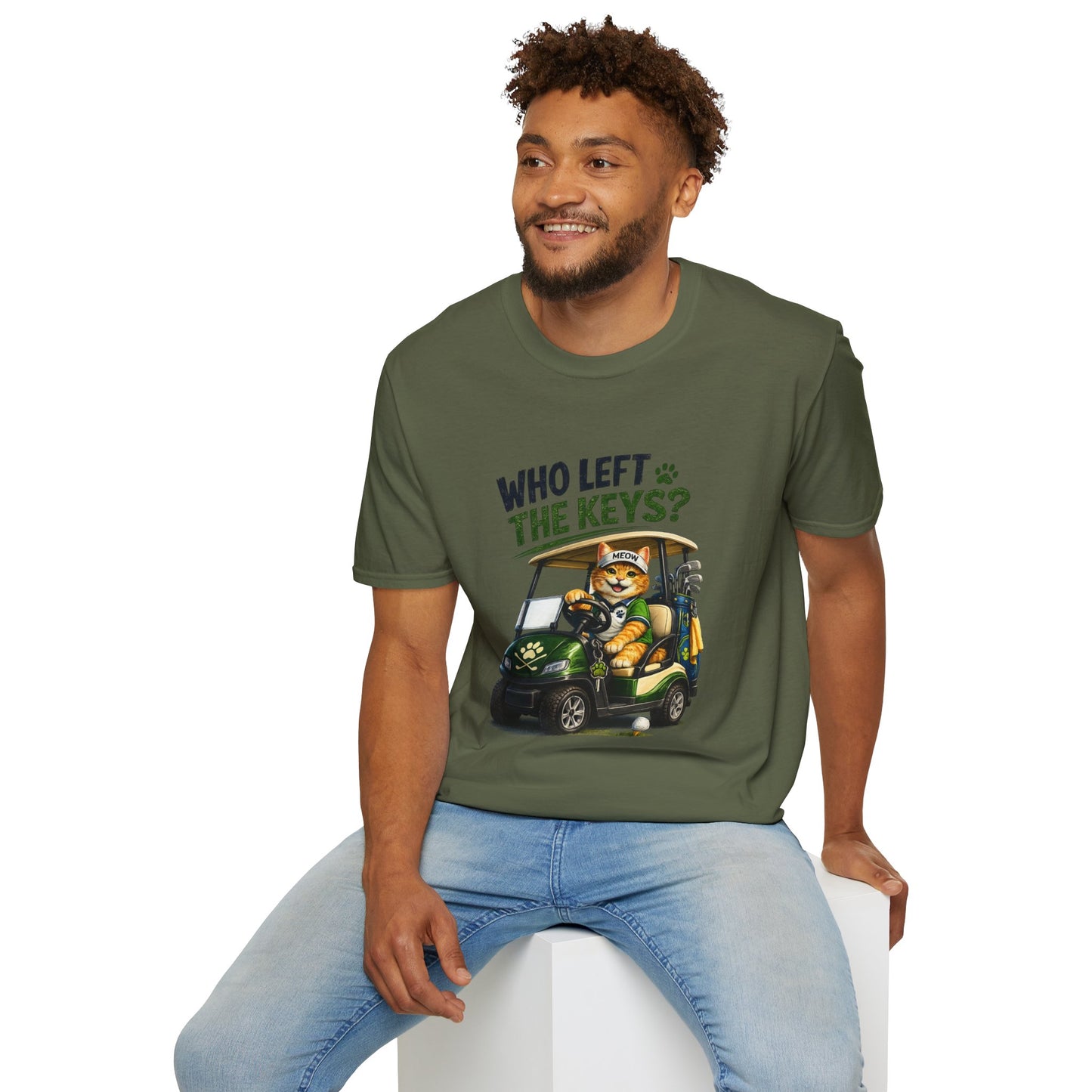 A military green short-sleeve crewneck t-shirt featuring a cartoon graphic of a cat driving a green golf cart with the text 'WHO LEFT THE KEYS?' printed on the chest.