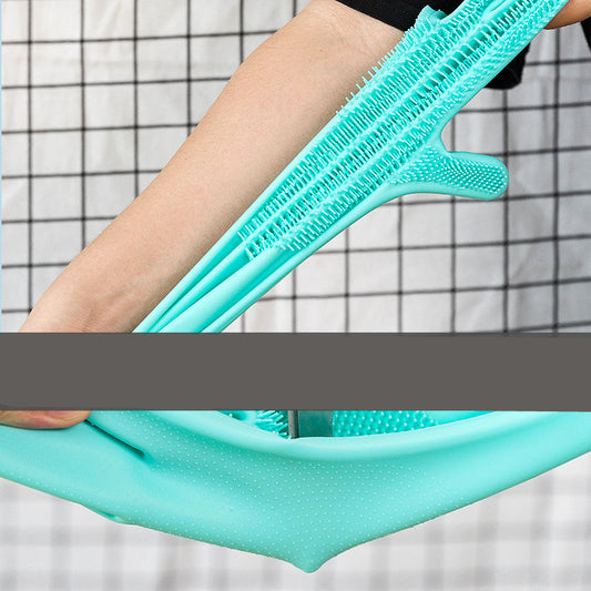 Turquoise silicone brush held by a person against a grid-patterned background
