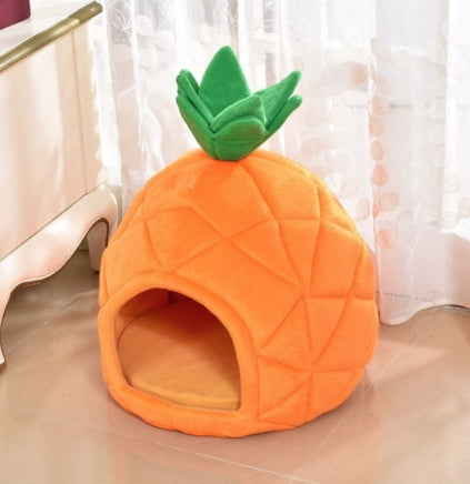 Pineapple-shaped pet bed on a light-colored floor with a white curtain in the background