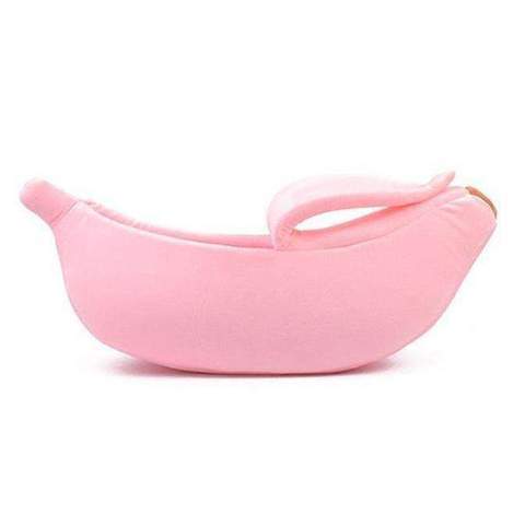 Pink banana-shaped pet bed on a white background