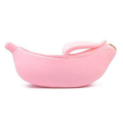 Pink banana-shaped pet bed on a white background