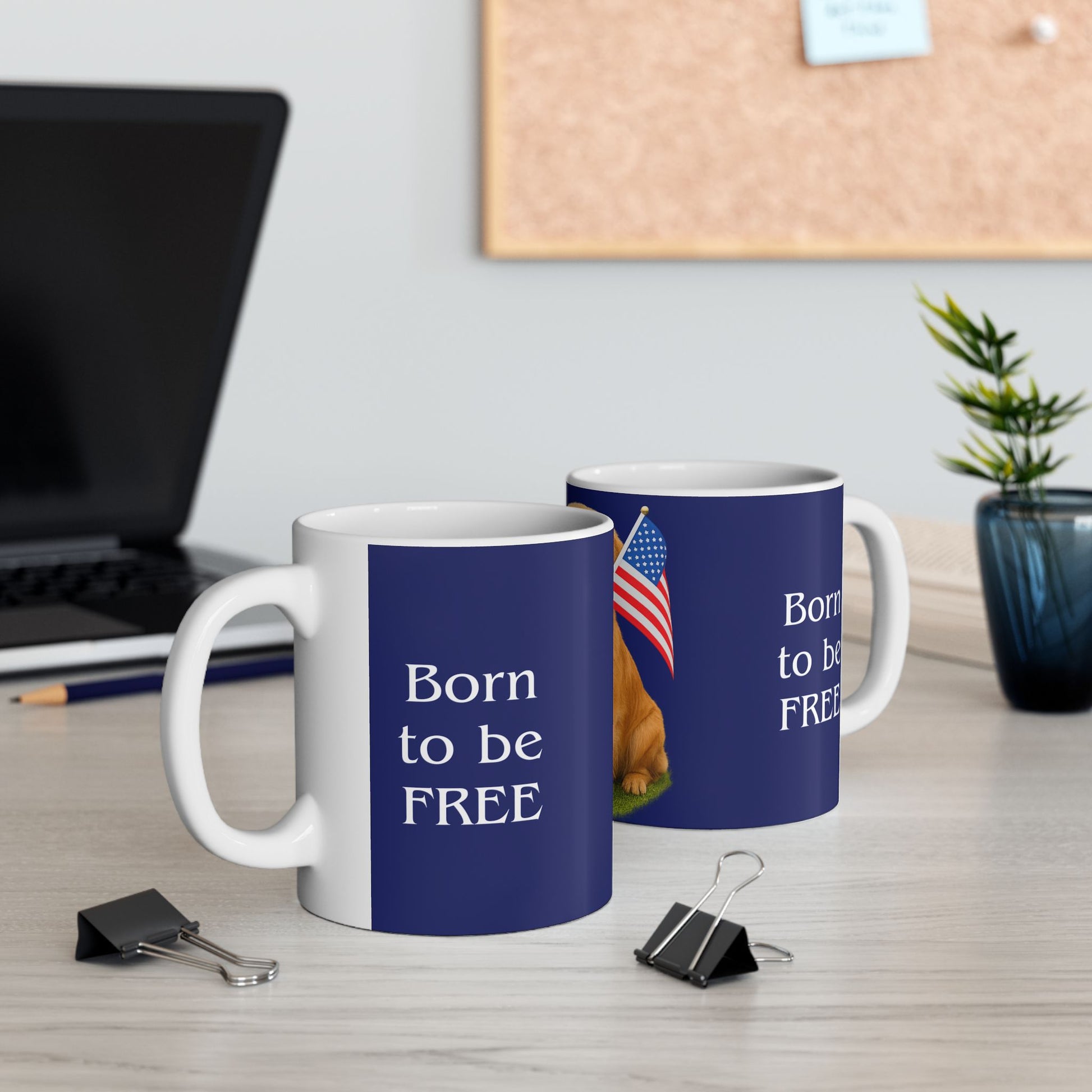 Two blue mugs with 'Born to be FREE' text and an American flag on a desk.