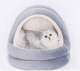 Cat inside a gray pet bed with a white background