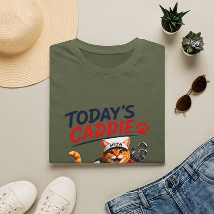 An olive green short-sleeve crewneck t-shirt featuring a cartoon graphic of an orange tabby cat wearing a cap and holding golf clubs, with the text 'TODAY'S CADDIE' 
