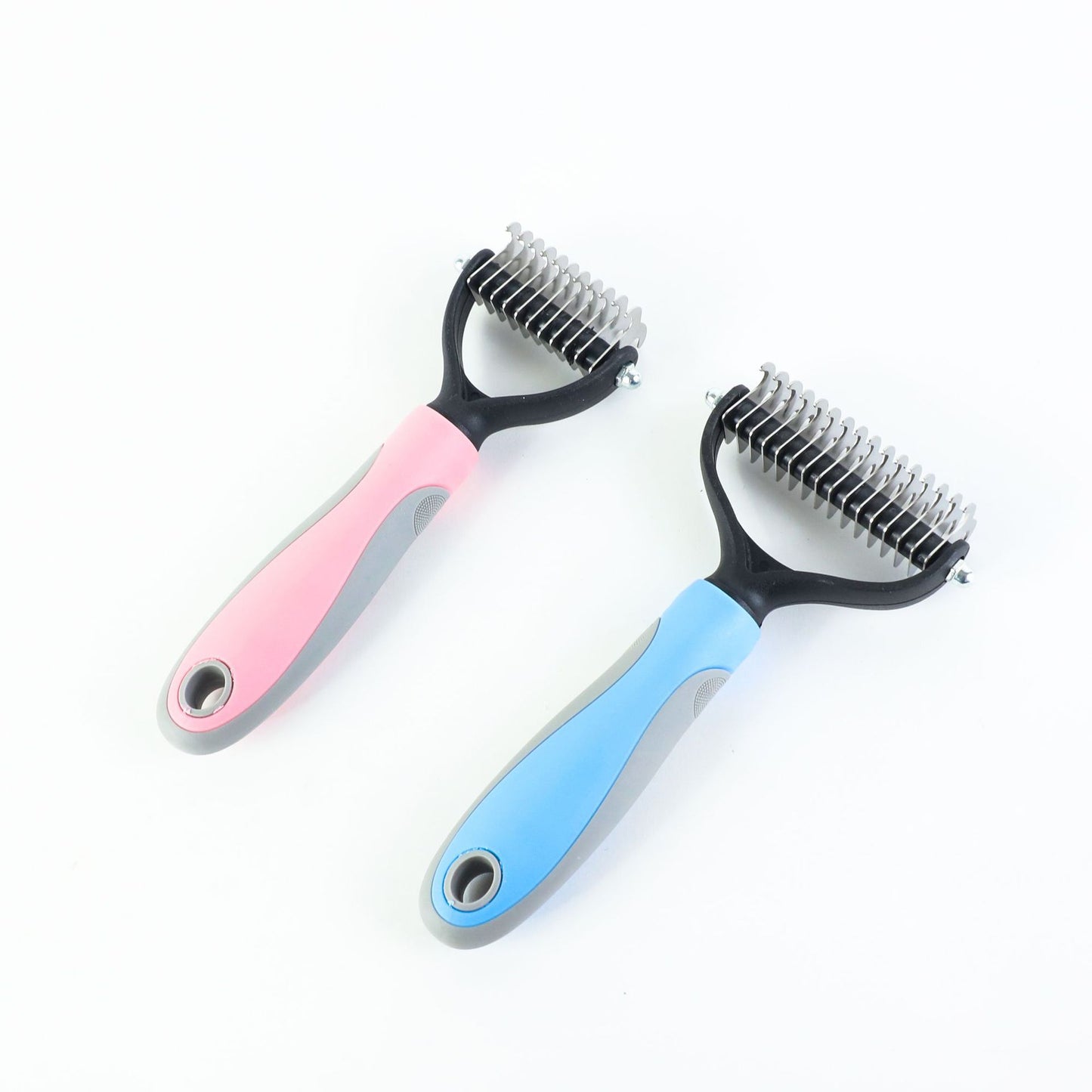 Two pet grooming brushes with pink and blue handles on a white background