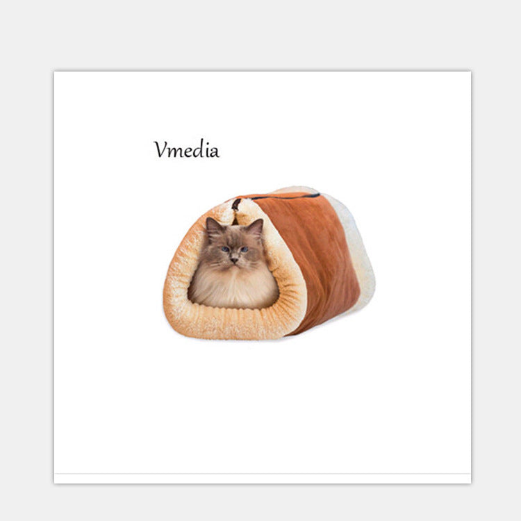 Cat lying in a brown and white pet cave on a white background with 'Vmedia' branding.