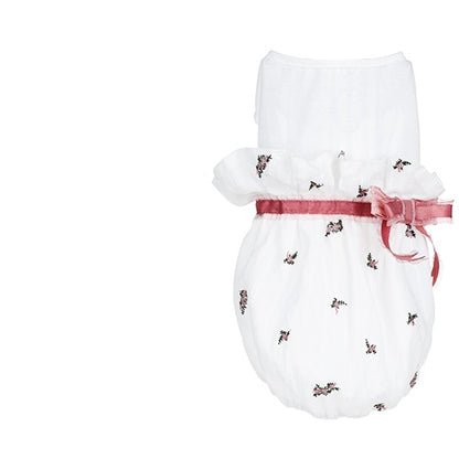 White baby romper with floral patterns and a pink ribbon on a white background