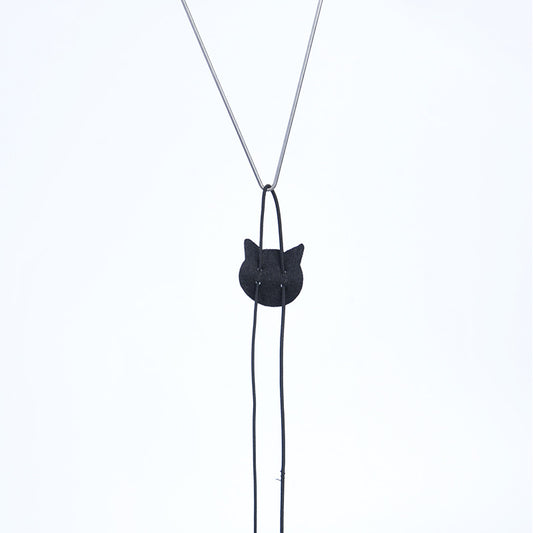 Black cat-shaped pendant on a silver chain against a white background