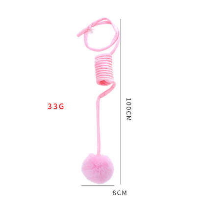 Pink spring with a ball attached, showing measurements on a white background