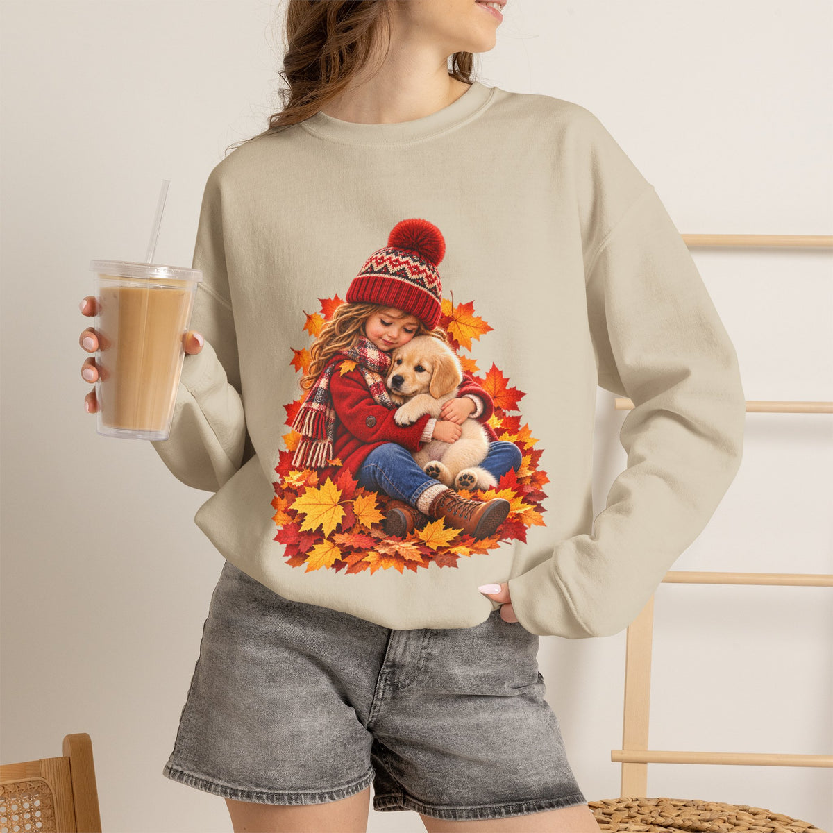 Woman holding a drink sand wearing the white Golden Moments girl and puppy fall sweatshirt
