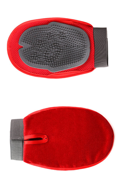 Red grooming mitt with textured surface on a white background