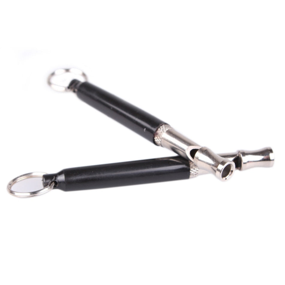 Two black and silver whistles on a white background