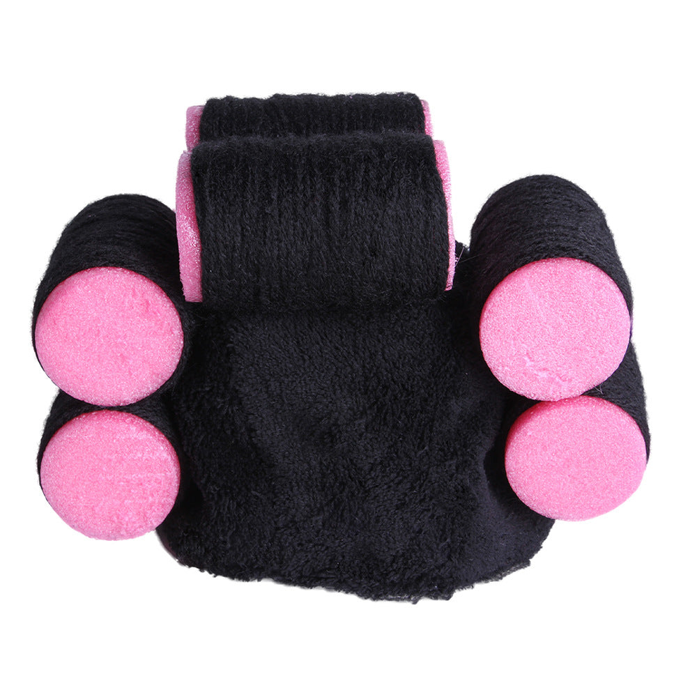 Black and pink hair roller on a white background