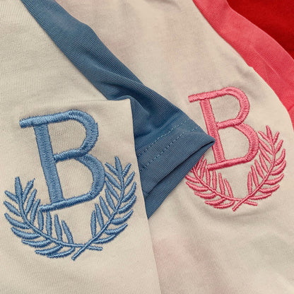 Two varsity jackets with embroidered 'B' letters on a close-up view.