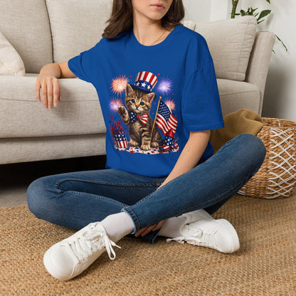 Person wearing a blue t-shirt with a graphic design sitting on a carpeted floor.