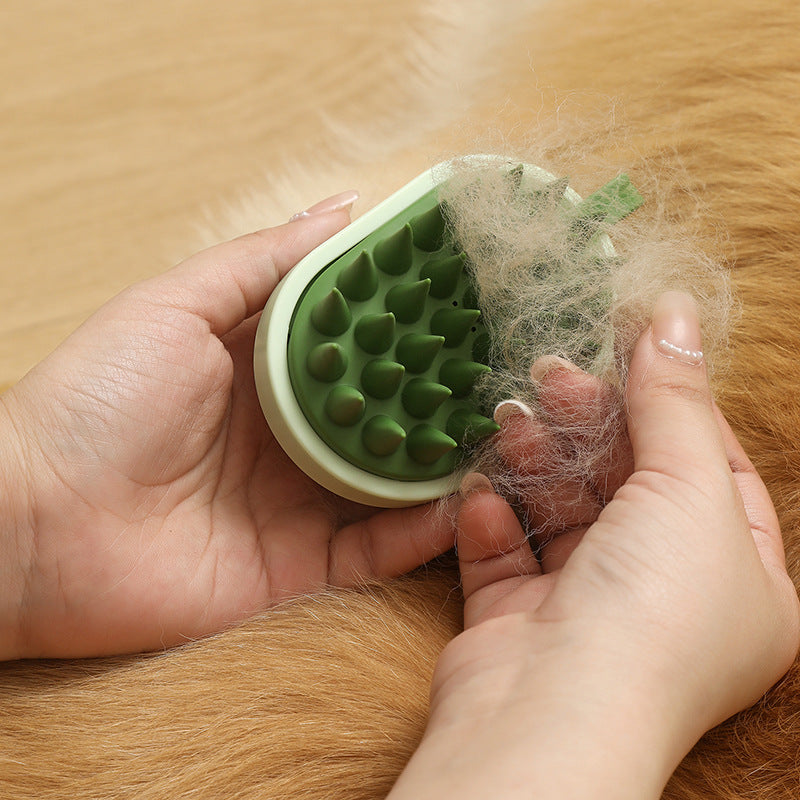 Green pet grooming brush with fur on a wooden surface