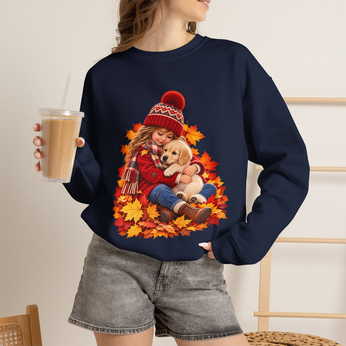 Woman holding a drink navy wearing the white Golden Moments girl and puppy fall sweatshirt