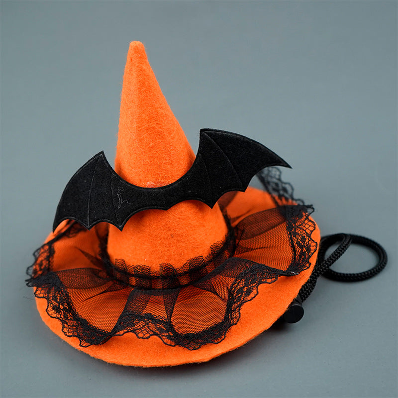 Orange Halloween witch hat with black lace and bats on a gray background