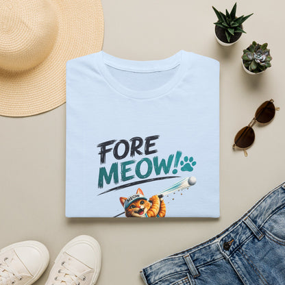 A folded light blue T-shirt with a 'FORE MEOW!' graphic and a cartoon cat, styled in a flat lay with a straw hat, white sneakers, sunglasses, small potted plants, and blue jeans on a beige background.
