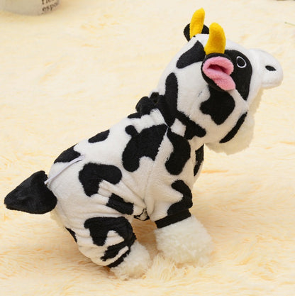 Plush cow toy with black and white pattern on a beige background